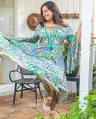 Dromana Maxi Dress featuring intricate floral print in blues and greens with deep V-neckline