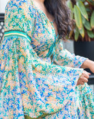 Dromana Maxi Dress featuring intricate floral print in blues and greens with deep V-neckline