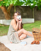 Eden Mini Dress featuring a delicate V-neck and unique boho print in blue, gold, and brown