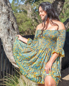 Kai Mini Dress featuring a vibrant paisley print in blue, orange, and yellow with shirred top