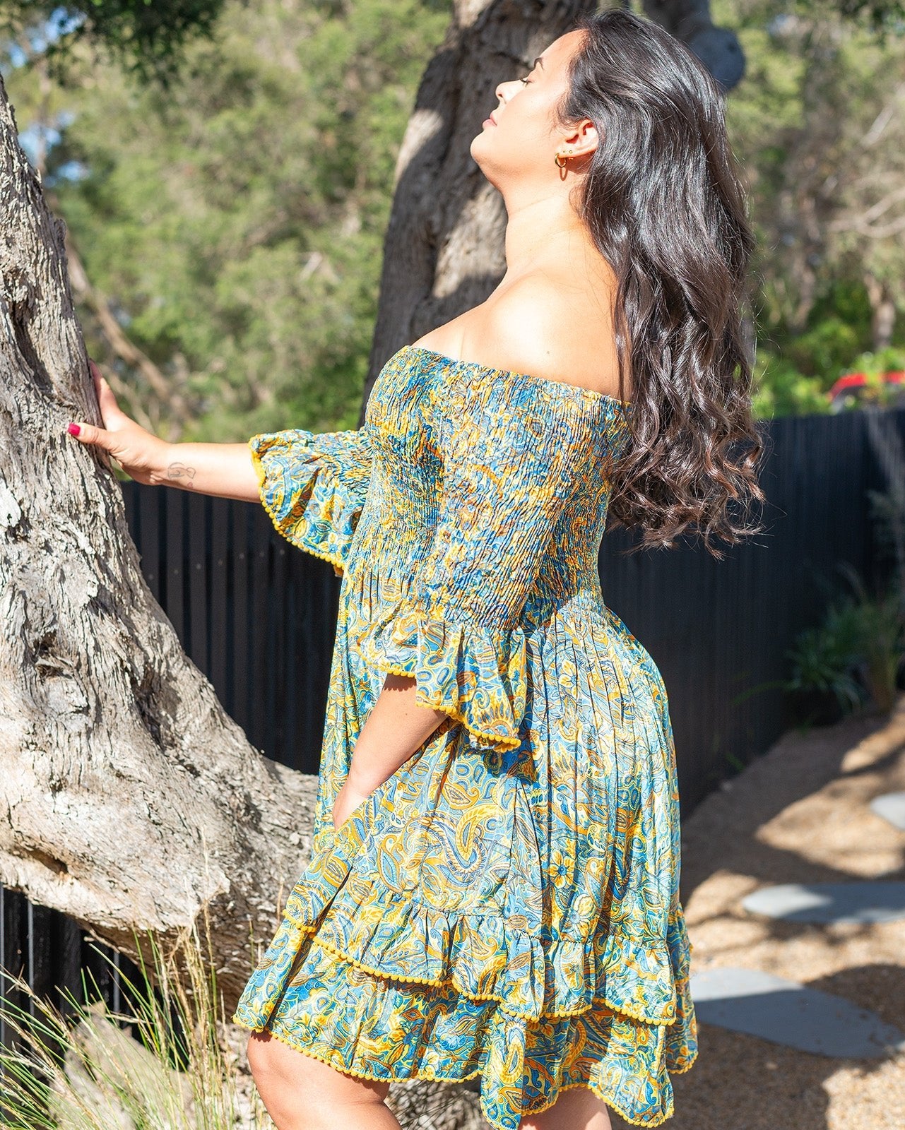 Kai Mini Dress featuring a vibrant paisley print in blue, orange, and yellow with shirred top