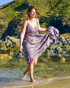 Noosa Maxi Dress featuring a vibrant paisley print in purple, teal, and blush with adjustable straps
