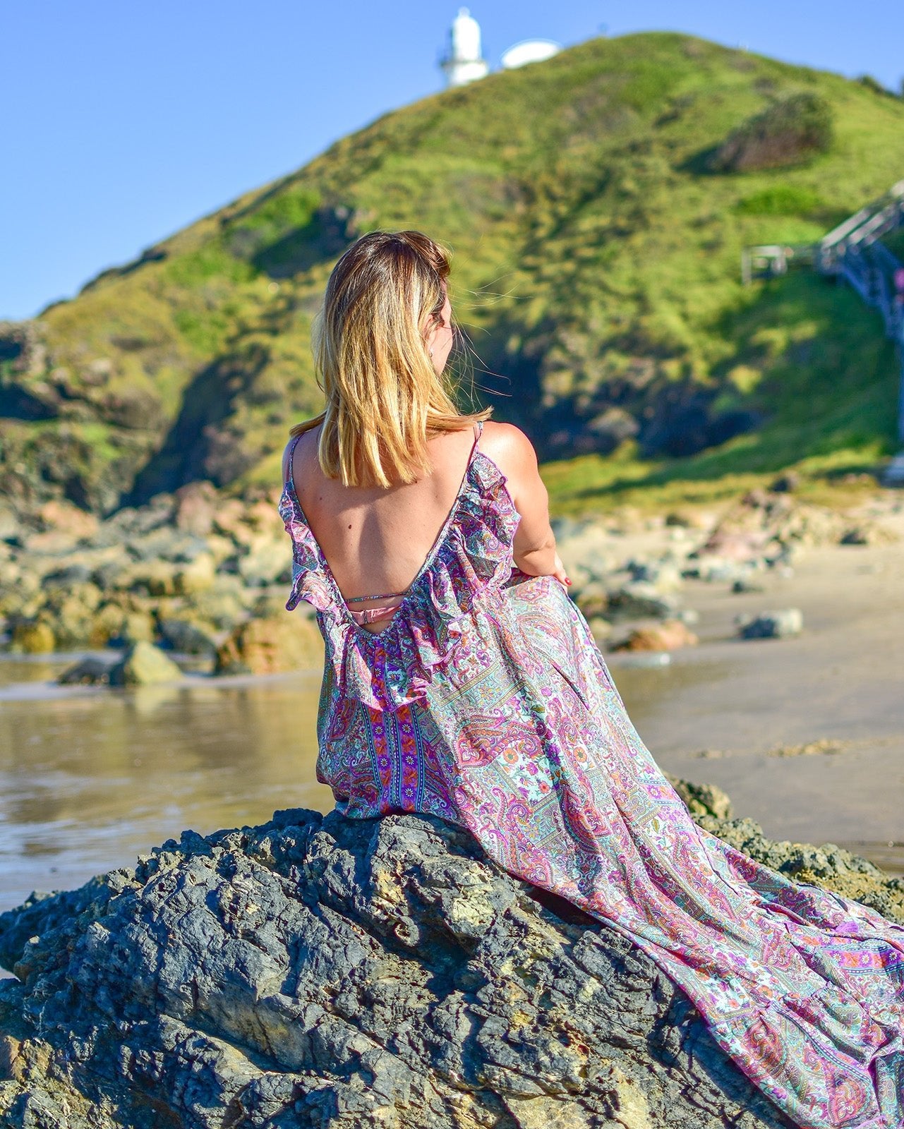 Noosa Maxi Dress featuring a vibrant paisley print in purple, teal, and blush with adjustable straps