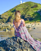 Noosa Maxi Dress featuring a vibrant paisley print in purple, teal, and blush with adjustable straps