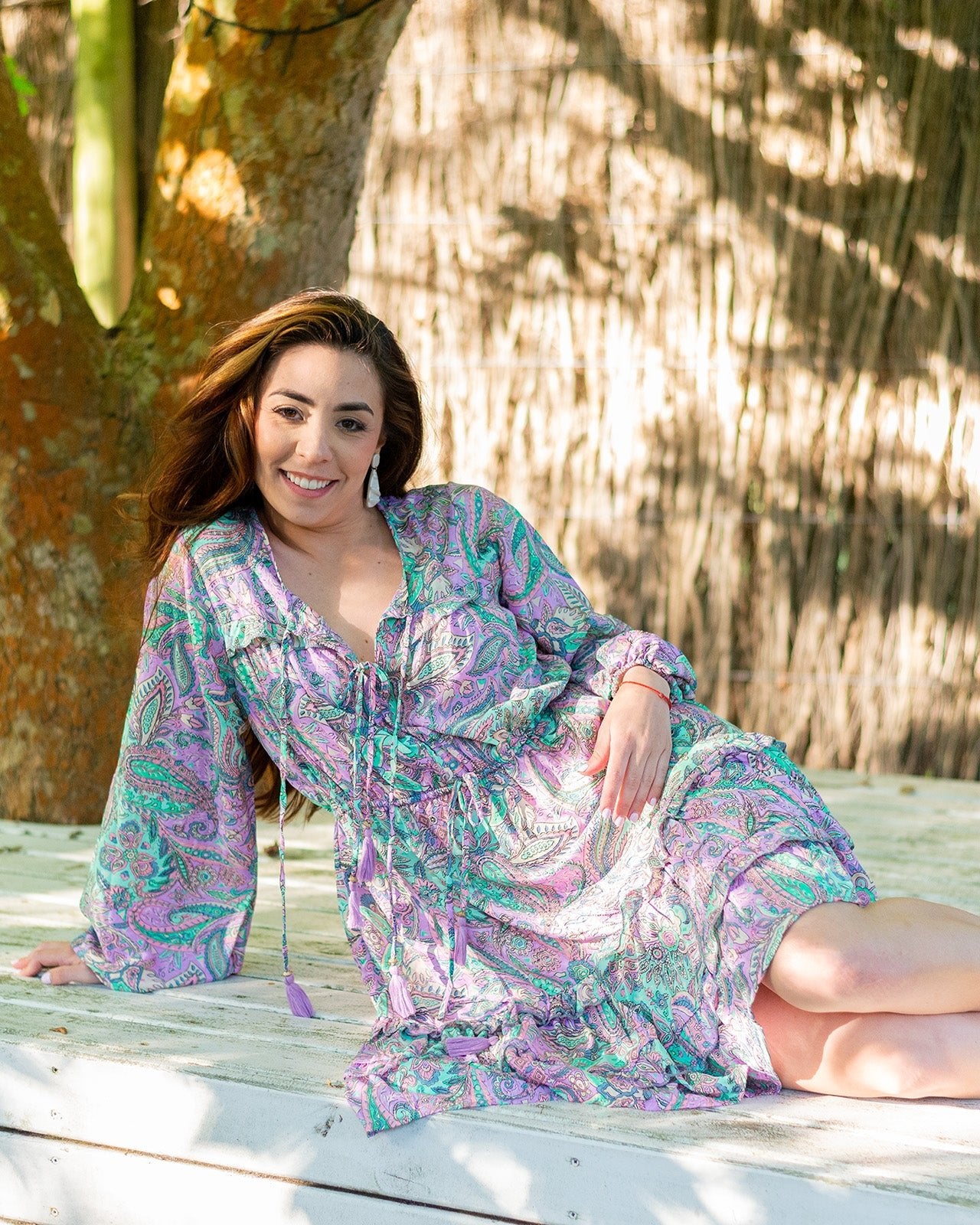 Nova Midi Dress showcasing a vibrant paisley print in lilac and green with long sleeves
