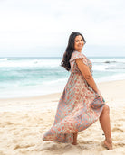 Talia Midi Dress showcasing warm tones and intricate paisley patterns with a flattering V-neckline