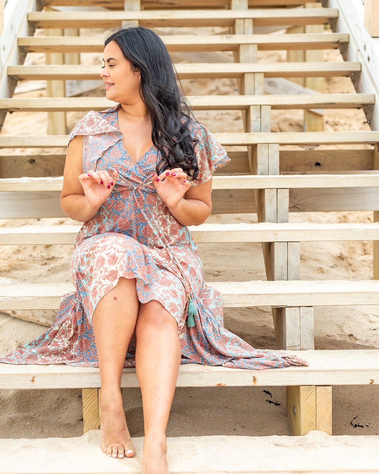 Talia Midi Dress showcasing warm tones and intricate paisley patterns with a flattering V-neckline