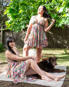 Tiwi Mini Dress featuring a vibrant print with adjustable halter neck and low-back design